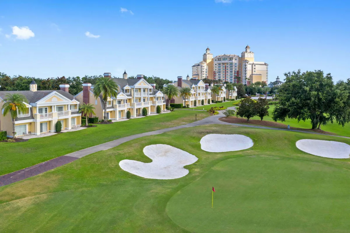 Golf fairway framed by homes with Reunion Grande in the distance